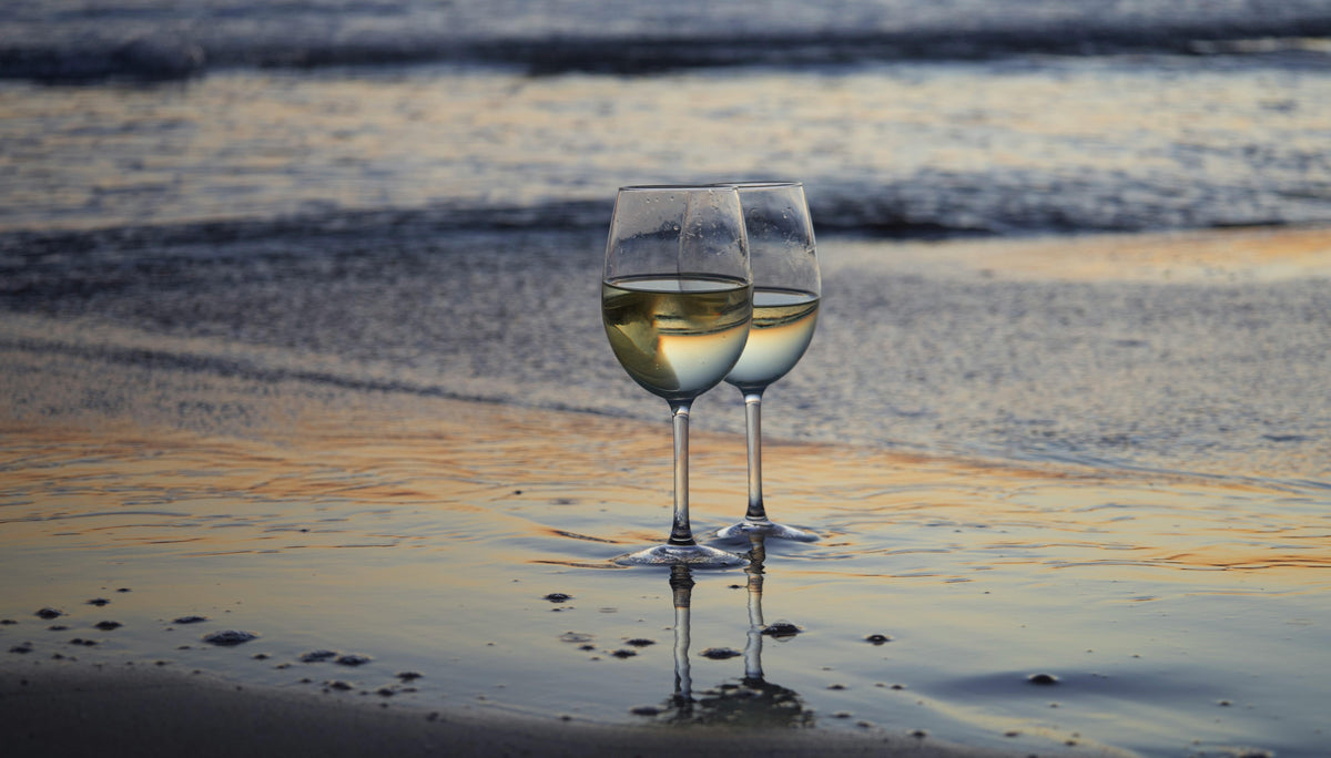 Two wine glasses on the beach